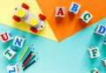 Wooden kids toys on colourful paper. Educational toys blocks, pyramid, pencils, numbers, train. Toys for kindergarten Royalty Free Stock Photo