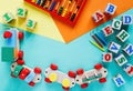 Wooden kids toys on colourful paper. Educational toys blocks, pyramid, pencils, numbers, train. Toys for kindergarten Royalty Free Stock Photo