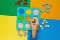 Wooden kids toys on colourful paper. Educational fractions. Toys for kindergarten, preschool or daycare.