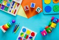 Wooden kids toys on colourful paper. Educational toys blocks, numbers, letters, train. Toys for kindergarten, preschool