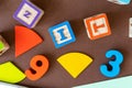 Wooden kids toys on colourful paper. Educational toys, blocks, pyramid, pencils, numbers, rainbow. Toys for kindergarten, Royalty Free Stock Photo