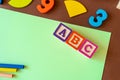 Wooden kids toys on colourful paper. Educational toys, blocks, pyramid, pencils, numbers, rainbow. Toys for kindergarten Royalty Free Stock Photo