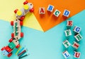 Wooden kids toys on colourful paper. Educational toys blocks, pyramid, pencils, numbers, train. Toys for kindergarten Royalty Free Stock Photo