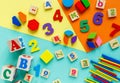 Wooden kids toys on colourful paper. Educational toys blocks, pyramid, pencils, numbers, train. Toys for kindergarten Royalty Free Stock Photo