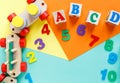 Wooden kids toys on colourful paper. Educational toys blocks, pyramid, pencils, numbers, train. Toys for kindergarten Royalty Free Stock Photo