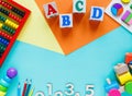 Wooden kids toys on colourful paper. Educational toys blocks, pyramid, pencils, numbers, train. Toys Royalty Free Stock Photo