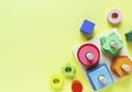 Wooden kids toys on colourful paper. Educational toys blocks. Toys for kindergarten, preschool or daycare.