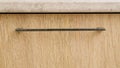 wooden kitchen facades close-up. black modern metal handle Royalty Free Stock Photo