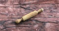 wooden kitchen rolling pin on a red wooden