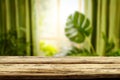 Wooden kitchen tabletop and window with blurred plants and window  background. Royalty Free Stock Photo