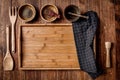 Wooden kitchen tools on dark brown table background. Royalty Free Stock Photo