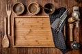 Wooden kitchen tools on dark brown table background. Royalty Free Stock Photo