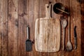 Wooden kitchen tools on dark brown table background. Royalty Free Stock Photo