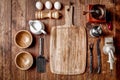 Wooden kitchen tools on dark brown table background. Royalty Free Stock Photo