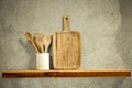 Wooden kitchen tools on wooden shelf. Copy empty space for your decoration and products. Beige brown retro wall background. Royalty Free Stock Photo