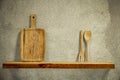 Wooden kitchen tools on wooden shelf. Copy empty space for your decoration and products. Beige brown retro wall background. Royalty Free Stock Photo