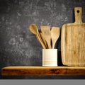 Wooden kitchen tools on wooden shelf. Copy space for your decoration and products. Dark gray retro wall background. Royalty Free Stock Photo