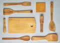 Wooden kitchen utensils and accessories for cooking on grey background