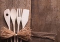 Wooden kitchen utensils on wooden background