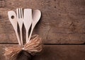 Wooden kitchen utensils on wooden background