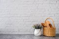 Wooden kitchenware and flower pot on white brick wall texture background Royalty Free Stock Photo