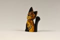 Wooden kitten figurine on a white background