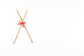 Wooden knitting needles and red and white polka dot ribbon bow on white background Royalty Free Stock Photo