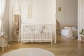 Wooden ladder with beige blanket white crib real photo