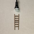 Wooden ladder with lamp light. Development, challenge, success concept Royalty Free Stock Photo
