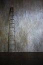 Wooden ladder leaning against textured wall. The concept of the career ladder Royalty Free Stock Photo