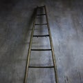 Wooden ladder leaning against textured wall. The concept of the career ladder Royalty Free Stock Photo