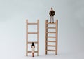 Wooden ladders and miniature people.