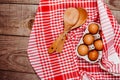 Wooden ladles and eggs on a red and white table rug