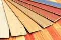 Wooden laminated construction planks assortment on parquet floor