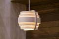 Wooden lamp on a brown background. Modern chandelier of wood in Scandinavian style