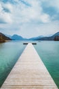 Wooden landing stage with alpine lake in summer Royalty Free Stock Photo