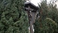 Wooden landmark with Christ crucified on cross. Art. View of wooden monument of crucified Jesus Christ standing between