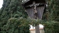 Wooden landmark with Christ crucified on cross. Art. View of wooden monument of crucified Jesus Christ standing between