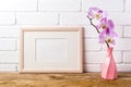 Wooden landscape frame mockup with pink orchid
