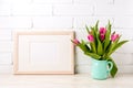 Wooden landscape frame mockup with pink tulips in jug