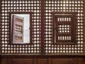 Wooden latticed window Mashrabiya with two small swinging sashes Royalty Free Stock Photo