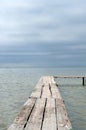 Wooden laying on a background of blue sea. Boardwalk pier on the beach Royalty Free Stock Photo