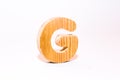 Wooden letter g carved from wood with a beautiful wooden texture Royalty Free Stock Photo