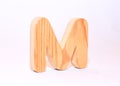Wooden letter m carved from wood with a beautiful wood texture Royalty Free Stock Photo