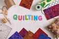 Wooden letters, consisting to the word quilting surrounded by accessories for quilting