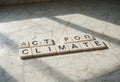 Wooden Letters Forming Message About Climate Action on Floor Surface Royalty Free Stock Photo
