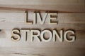 Wooden letters making the word Live Strong