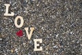 Wooden letters forming the word love with a red heart on a background of beach sand.concept valentine`s day Royalty Free Stock Photo