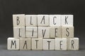 Wooden letters forming words 'Black lives matter' on dark black background Justice or blm concept