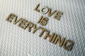 Wooden letters forming the words Love Is Everything for everyone
